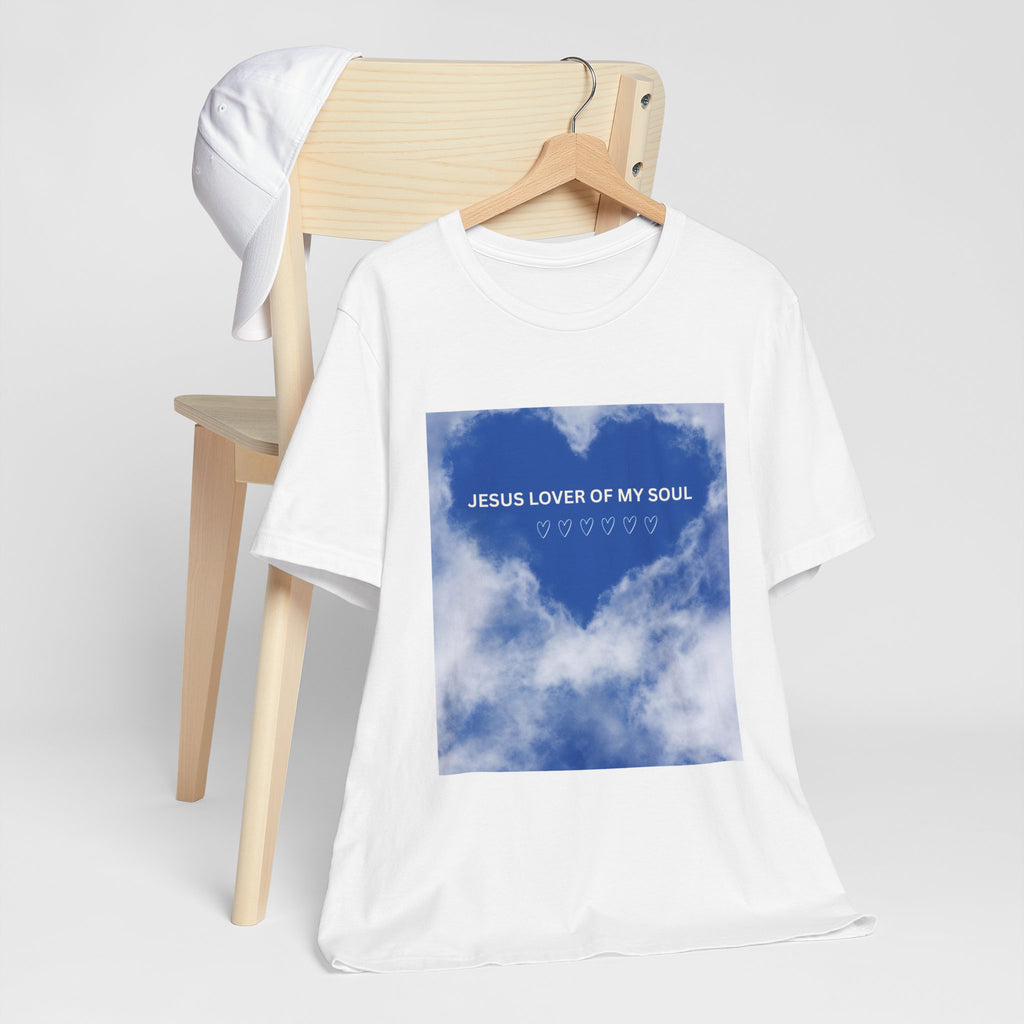 White t-shirt with blue graphic and text on a wooden chair against a white background